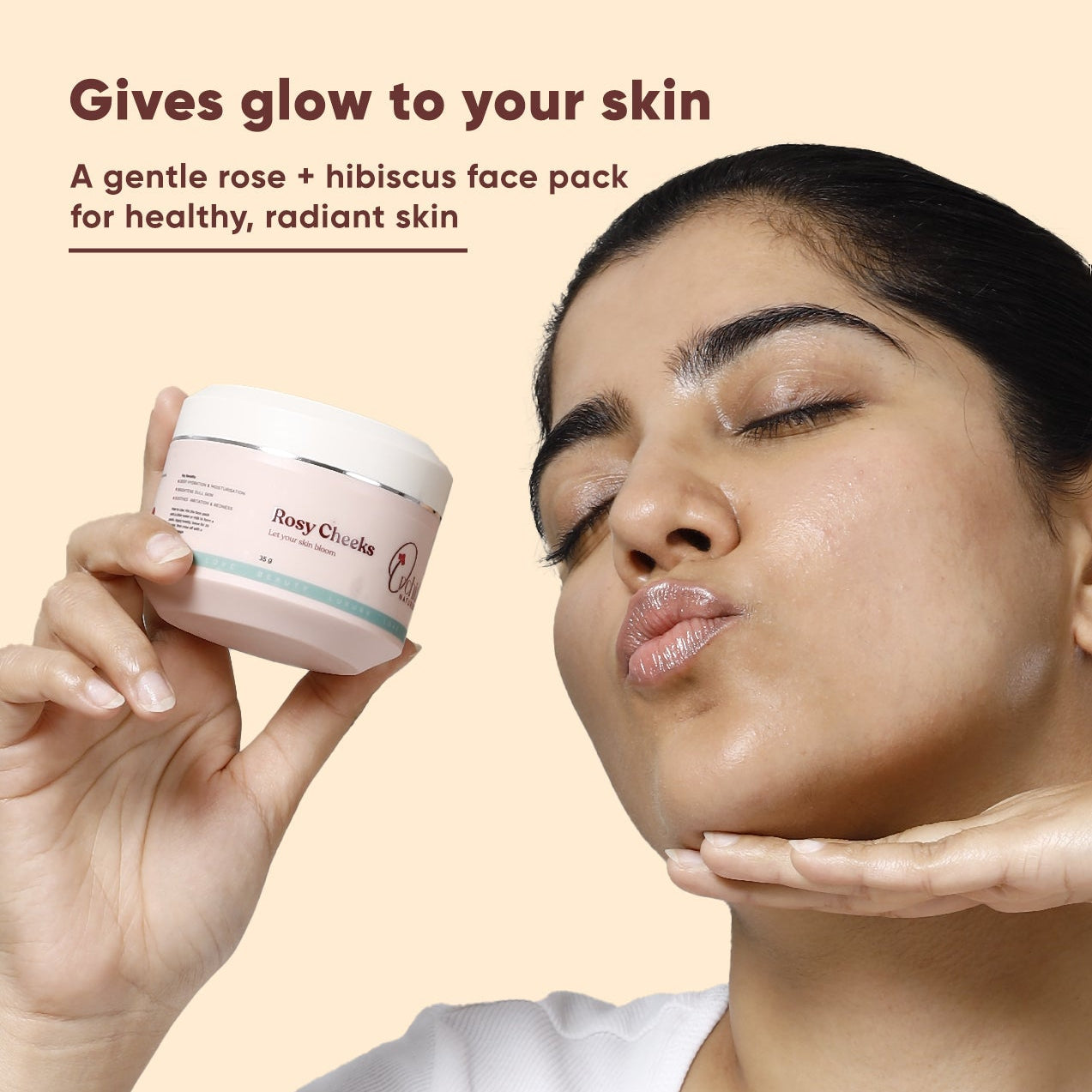 Woman holding a face pack container with text about its benefits on a beige background