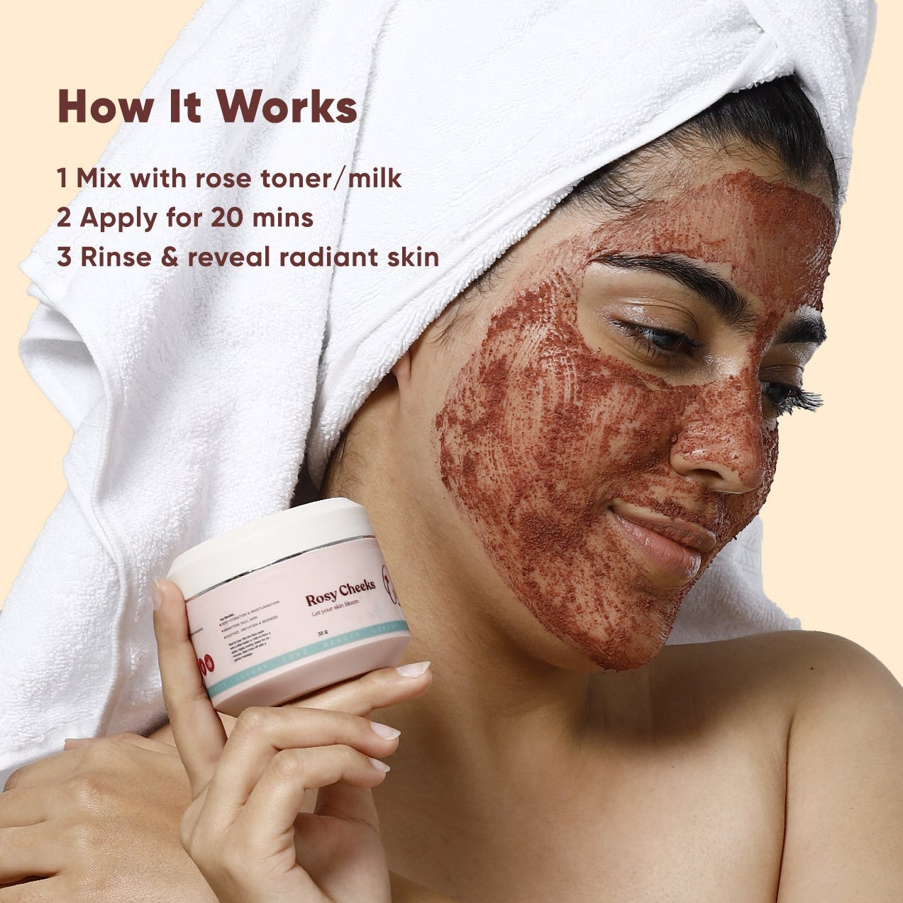 Woman applying a red facial mask with a container labeled 'Rose Toner' on a beige background.