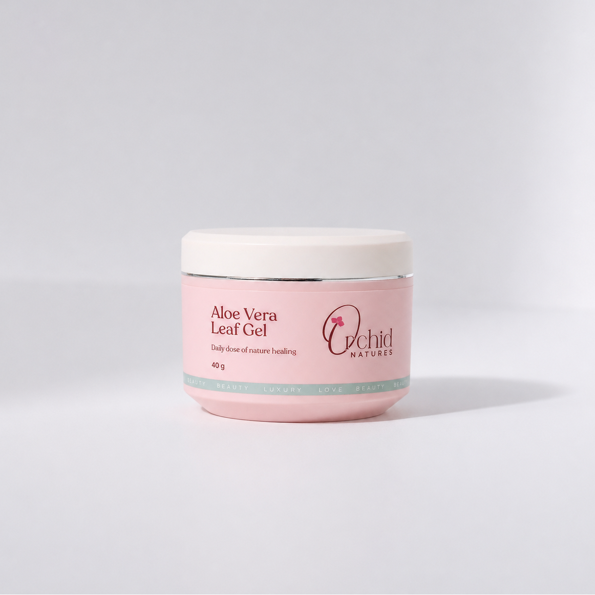 Pink jar of Aloe Vera Leaf Gel with Orchid Naturals branding on a light gray background
